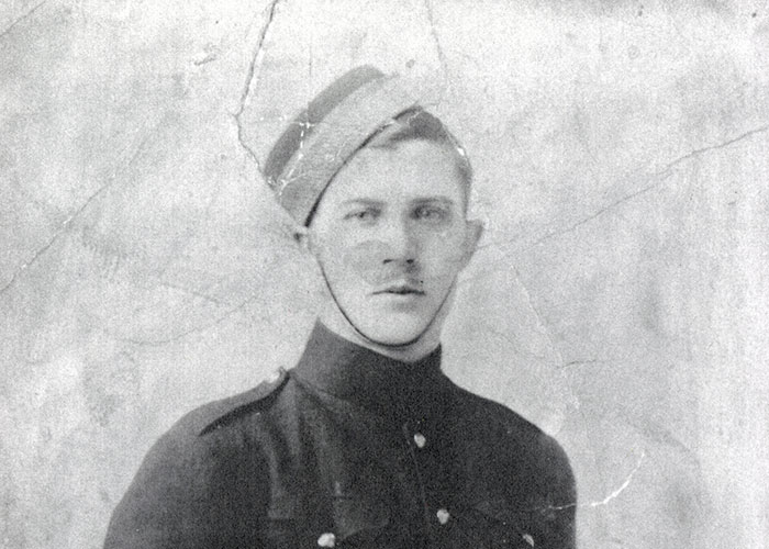 Black and white photograph of a young man wearing a military uniform.