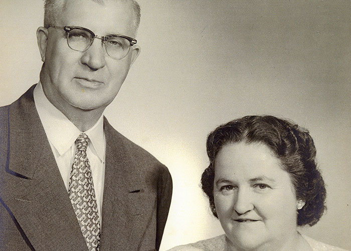 Black and white studio portrait of two people.